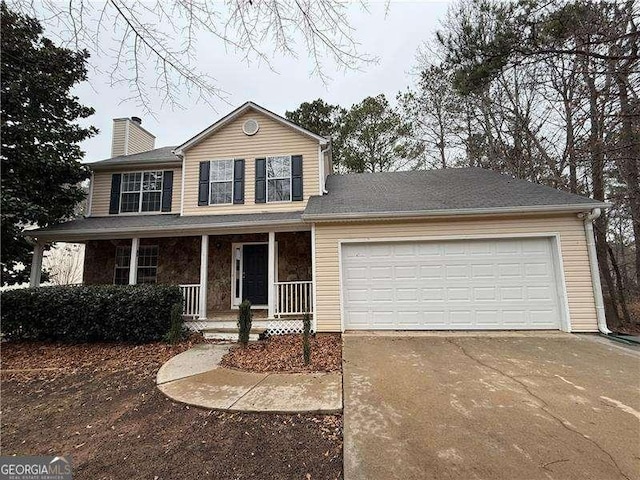 traditional-style house with a garage, covered porch, a chimney, and concrete driveway