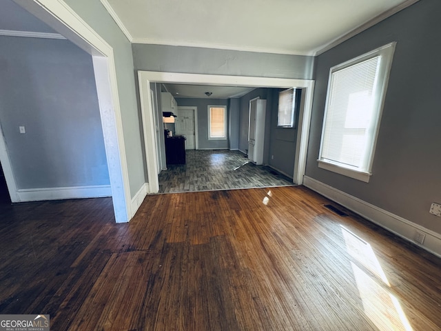 hall with crown molding, baseboards, and wood finished floors