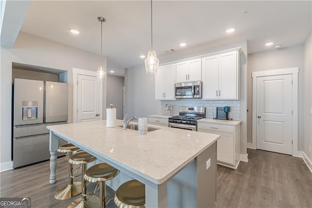 1703 Prospect Way, Conyers, GA 30094 - kitchen featuring stainless steel appliances, dark wood-type flooring, a kitchen island with sink, white cabinets, and recessed lighting
