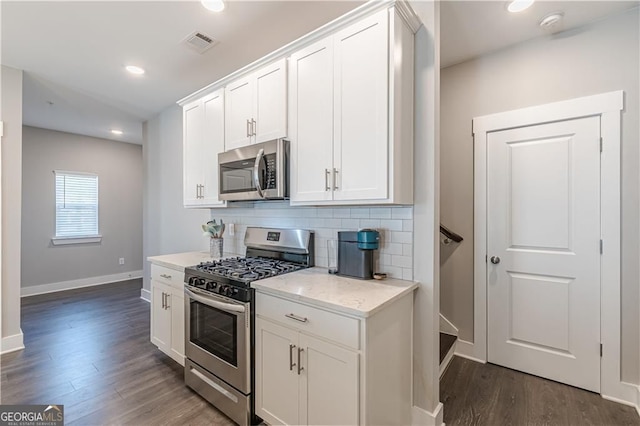 1703 Prospect Way, Conyers, GA 30094 - kitchen with appliances with stainless steel finishes, tasteful backsplash, dark wood-type flooring, white cabinets, and recessed lighting