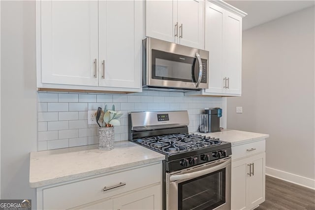 1703 Prospect Way, Conyers, GA 30094 - kitchen featuring stainless steel appliances, wood finished floors, white cabinetry, and tasteful backsplash