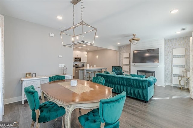 1703 Prospect Way, Conyers, GA 30094 - dining room with wood finished floors, a chandelier, a fireplace, and recessed lighting