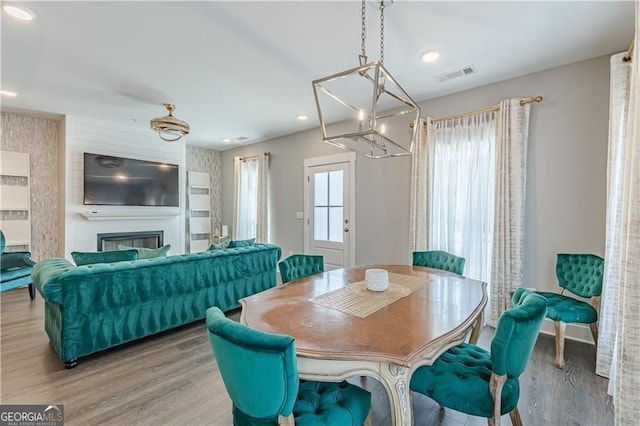 1703 Prospect Way, Conyers, GA 30094 - dining area with wood finished floors, recessed lighting, a glass covered fireplace, and a chandelier