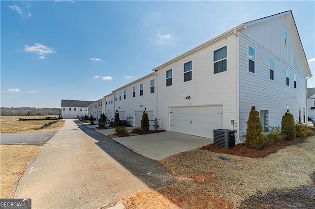 1703 Prospect Way, Conyers, GA 30094 - view of property exterior featuring an attached garage, concrete driveway, and board and batten siding