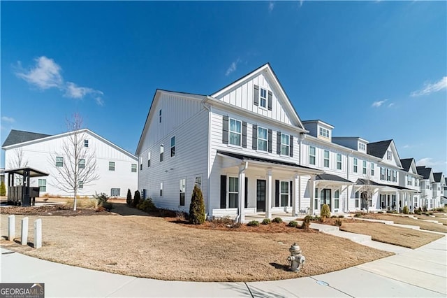 1703 Prospect Way, Conyers, GA 30094 - townhome / multi-family property featuring a porch, board and batten siding, and a residential view
