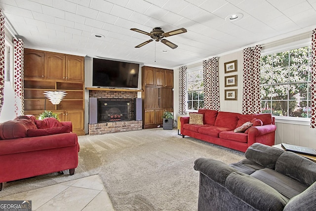 living area with a fireplace, recessed lighting, ornamental molding, light carpet, and ceiling fan