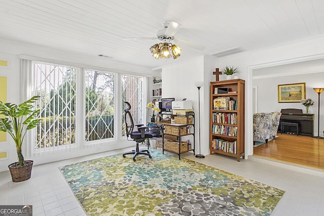 office area featuring ornamental molding, tile patterned floors, visible vents, and a ceiling fan