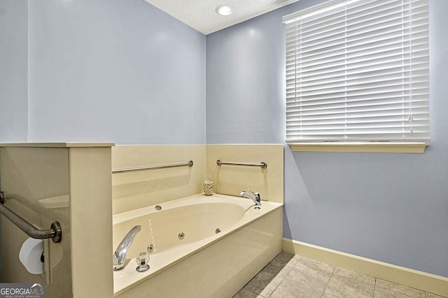 full bathroom with a jetted tub, baseboards, and tile patterned floors