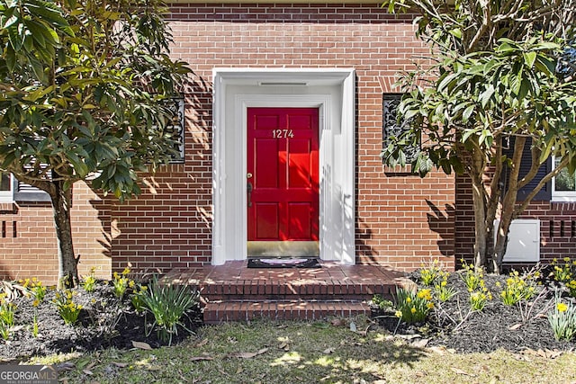 property entrance with brick siding