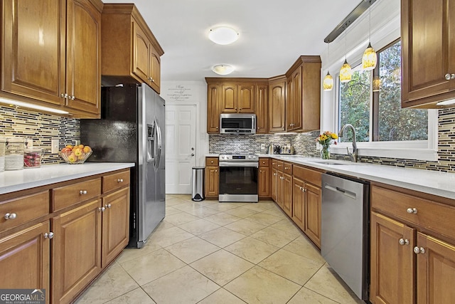 kitchen with stainless steel appliances, brown cabinetry, and decorative backsplash