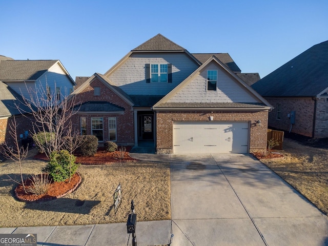 craftsman-style house featuring brick siding, driveway, and an attached garage