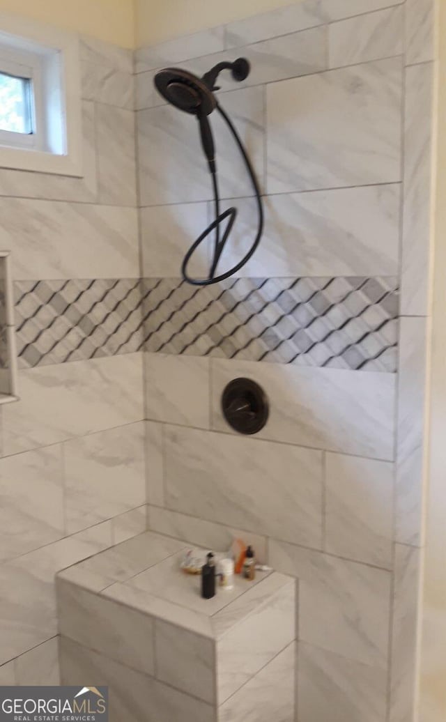 bathroom with tiled shower