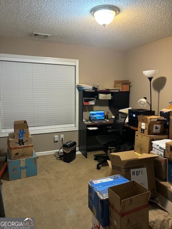 home office with a textured ceiling, carpet, and visible vents