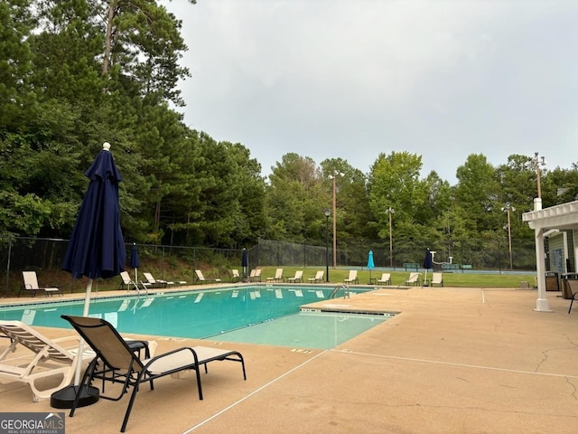 pool featuring a patio area and fence