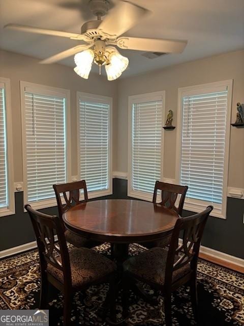 dining area with ceiling fan and baseboards