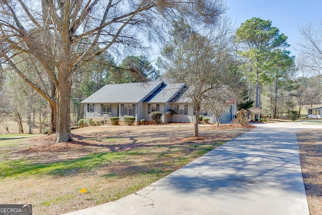 single story home with covered porch and concrete driveway