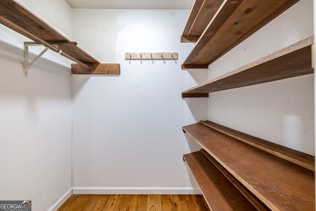 spacious closet with light wood finished floors