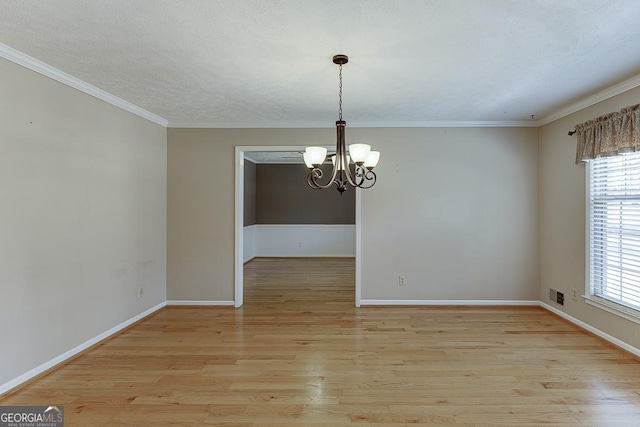unfurnished dining area with a chandelier, plenty of natural light, light wood-style floors, baseboards, and ornamental molding