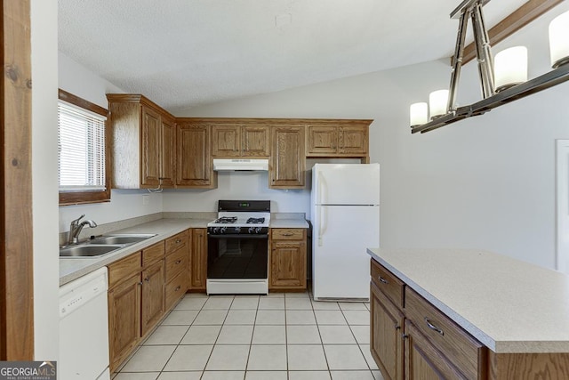 kitchen featuring white appliances, a sink, under cabinet range hood, lofted ceiling, and light countertops