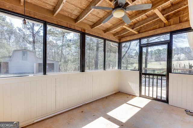 unfurnished sunroom featuring ceiling fan