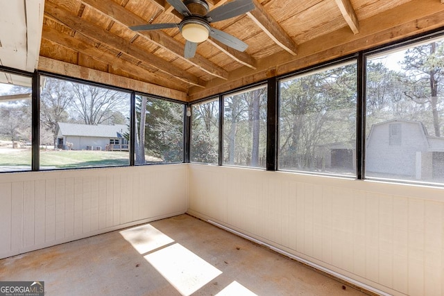 unfurnished sunroom featuring ceiling fan