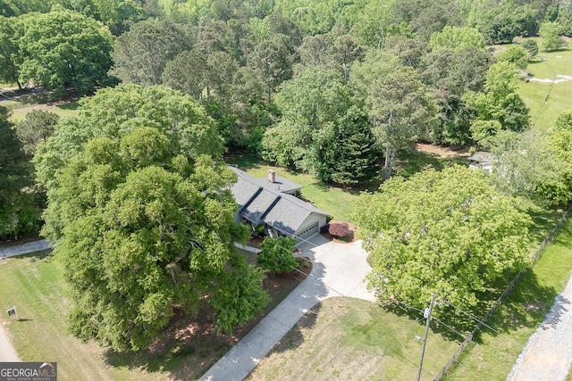 view of property location with a forest