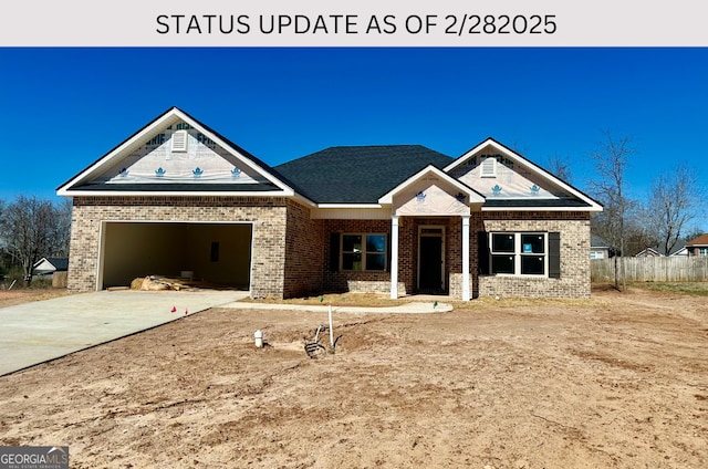 view of front of property featuring concrete driveway, brick siding, an attached garage, and fence