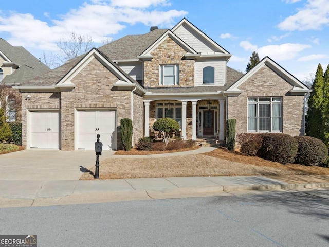 craftsman-style home featuring covered porch, driveway, brick siding, and an attached garage