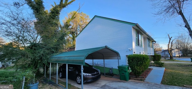 view of property exterior with a detached carport and driveway