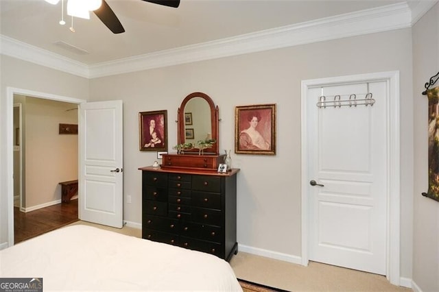 bedroom with baseboards, ornamental molding, and a ceiling fan