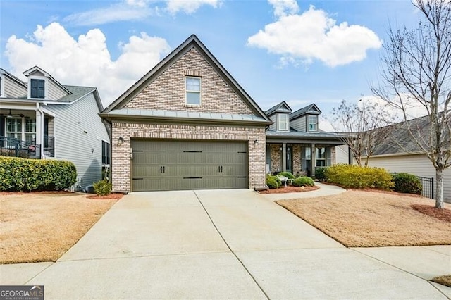 traditional-style house featuring a garage, driveway, and brick siding