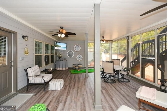 sunroom / solarium featuring ceiling fan