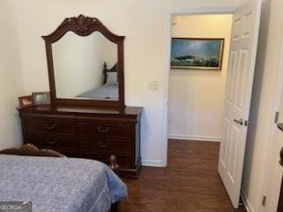 bedroom featuring wood finished floors and baseboards