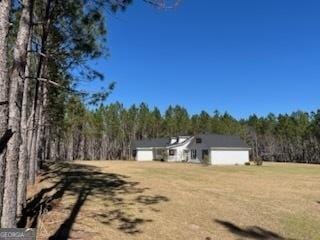 view of yard with a wooded view