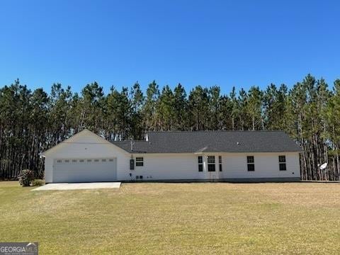 single story home with an attached garage, driveway, and a front lawn