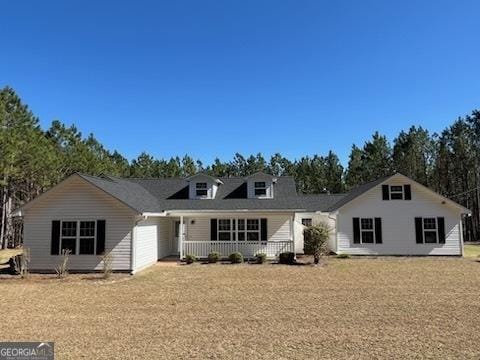 rear view of property with covered porch