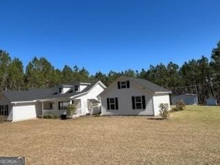 view of front of property featuring a garage and a front lawn