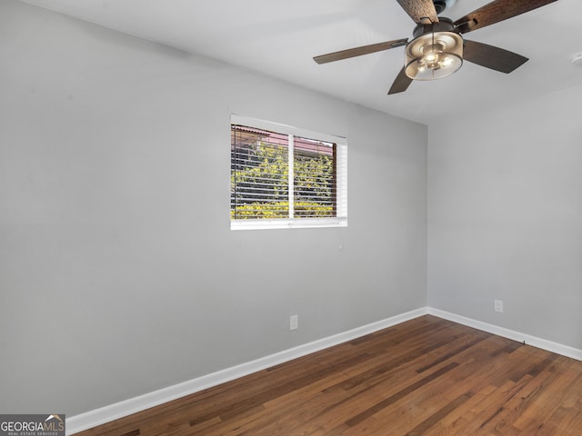 unfurnished room with ceiling fan, baseboards, and dark wood-style flooring