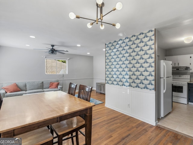 dining area featuring recessed lighting, light wood-style flooring, a ceiling fan, and wainscoting