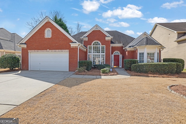 traditional-style house with driveway and brick siding