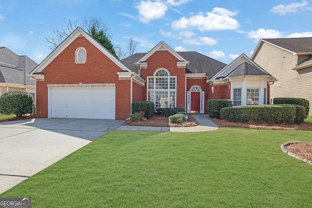 view of front of home with driveway, an attached garage, a front yard, and brick siding