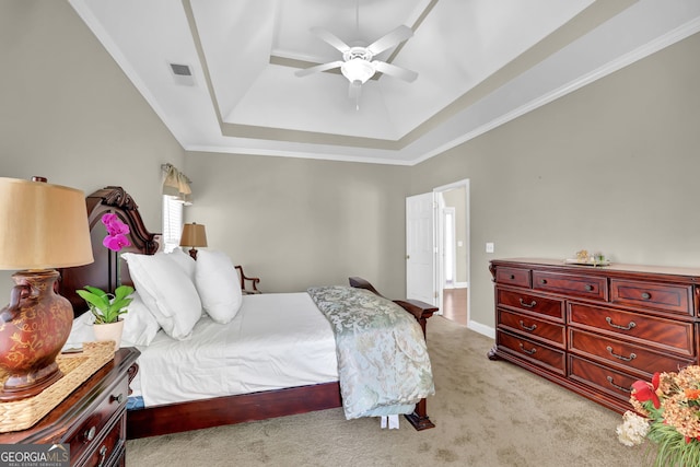 bedroom with ceiling fan, light carpet, visible vents, a raised ceiling, and crown molding