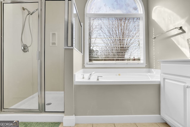 bathroom with tile patterned flooring, a shower stall, and a bath