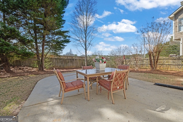 view of patio featuring a fenced backyard and outdoor dining area