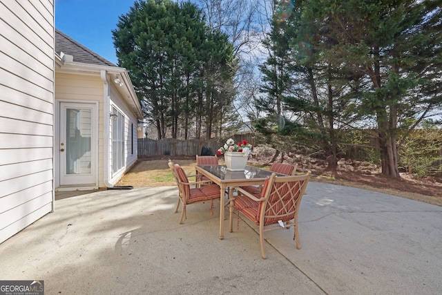 view of patio / terrace featuring outdoor dining area and fence