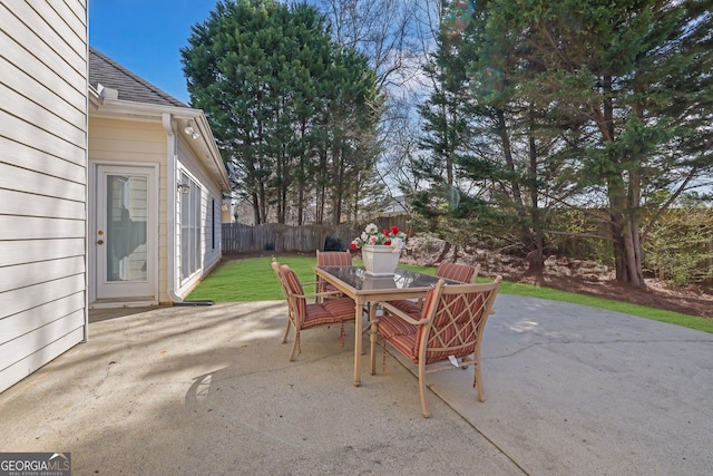 view of patio with outdoor dining area and fence