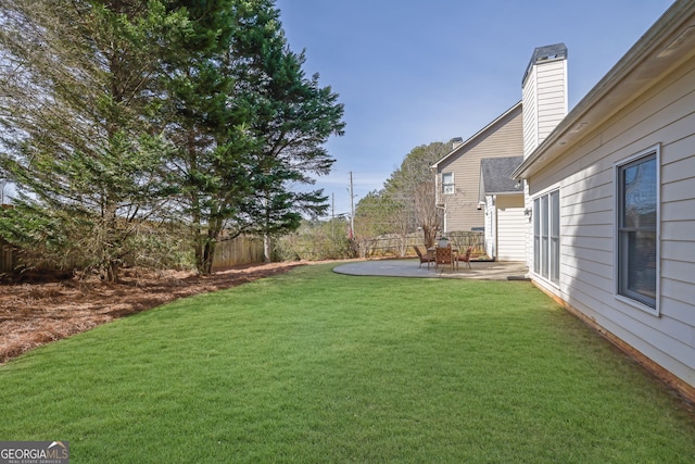 view of yard with fence and a patio