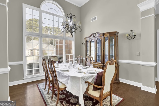 dining room featuring dark wood-style floors, a wealth of natural light, a chandelier, and visible vents