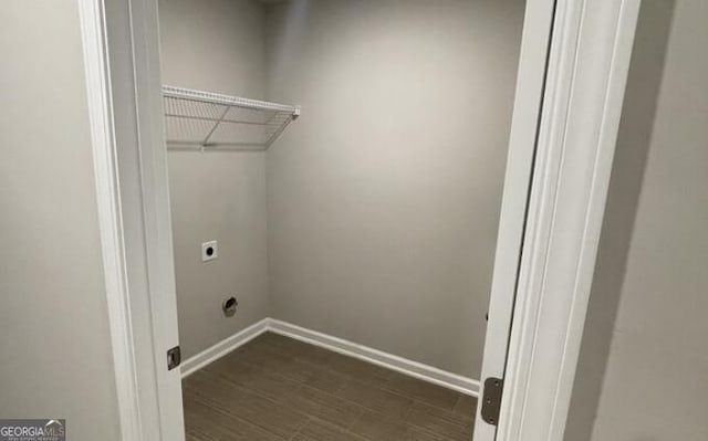 laundry area with dark wood-style floors, laundry area, electric dryer hookup, and baseboards