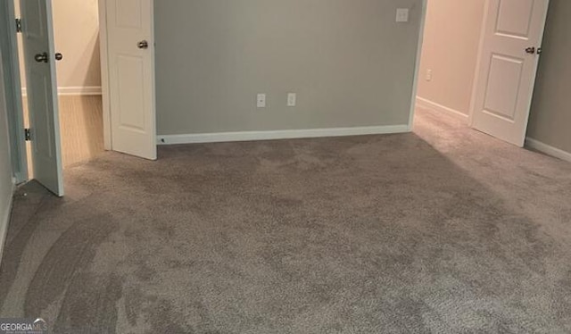 unfurnished bedroom featuring carpet and baseboards